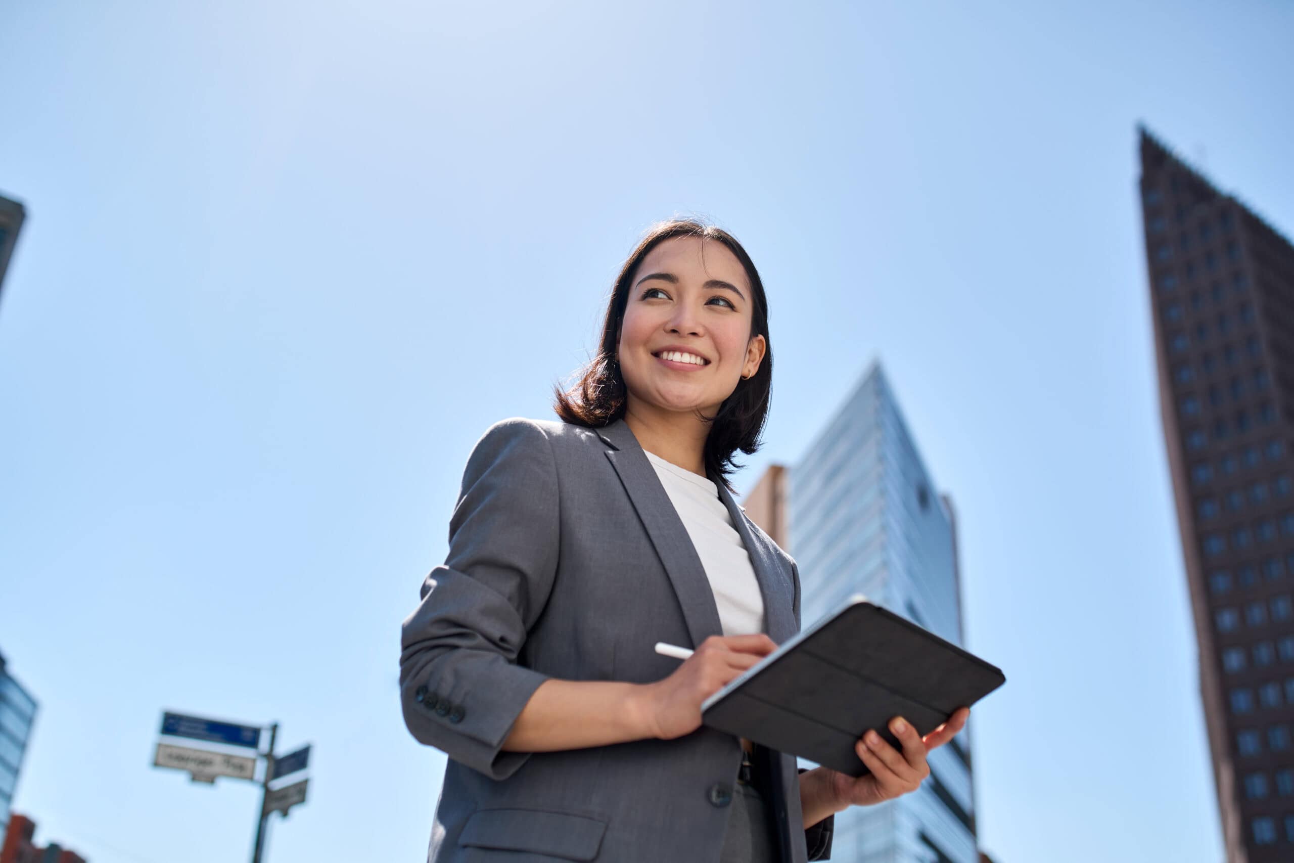 Contact Us 11 smiling young asian businesswoman using digital ta 2026 03 18 16 03 17 utc scaled